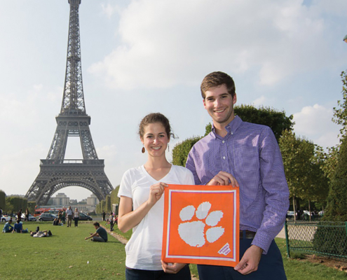 France Sara Webb \u201914 and Alex Devon \u201914 show Clemson pride in front of the Eiffel Tower while visiting Paris.